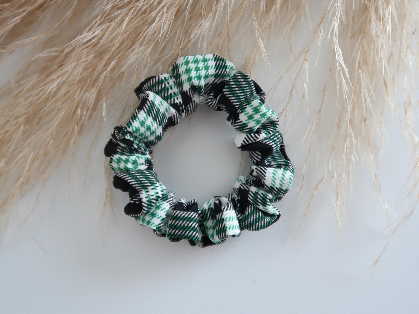 Green and black checkered scrunchie on a light background