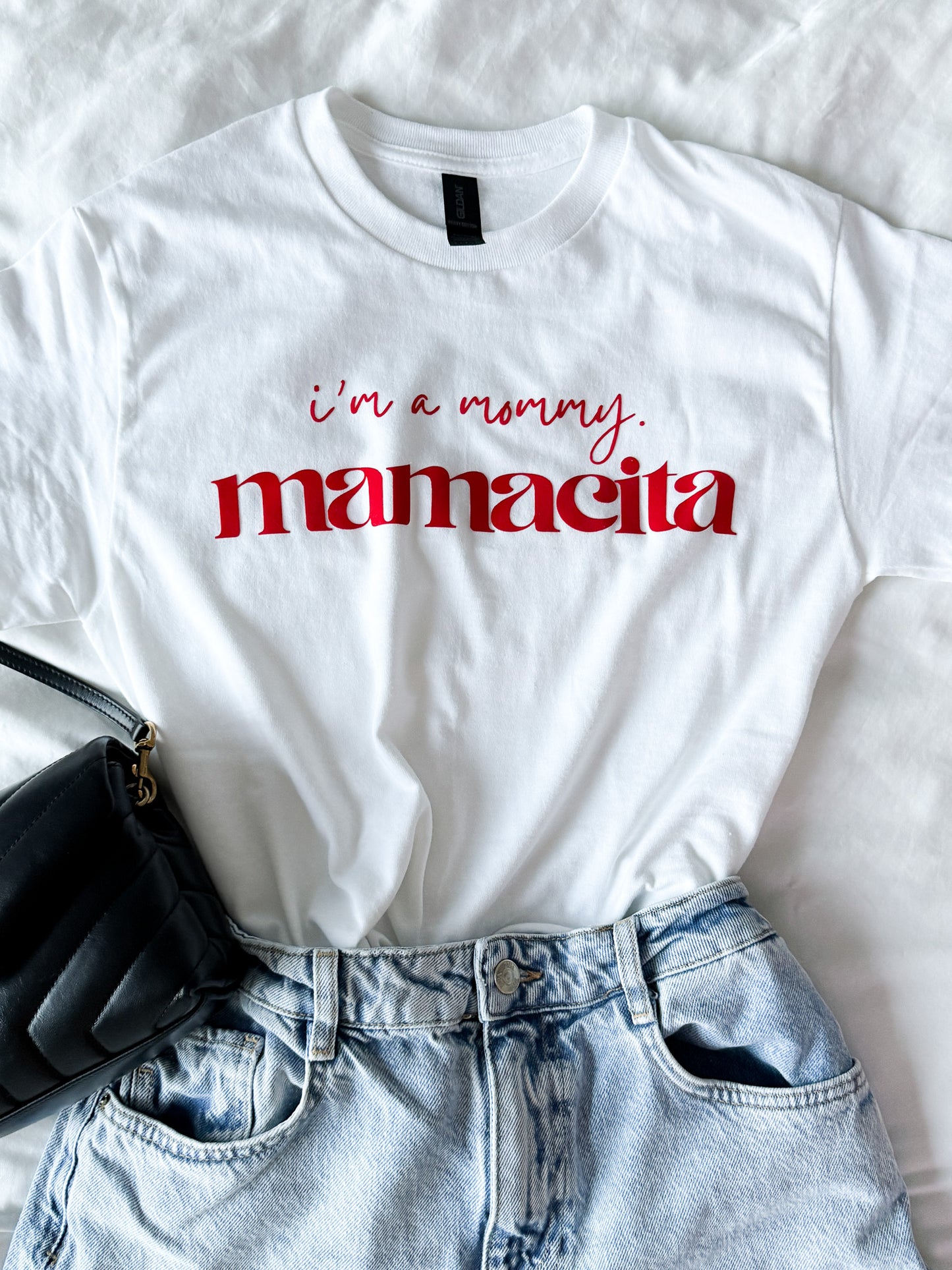 White t-shirt with 'i'm a mommy mamacita' text on a white background