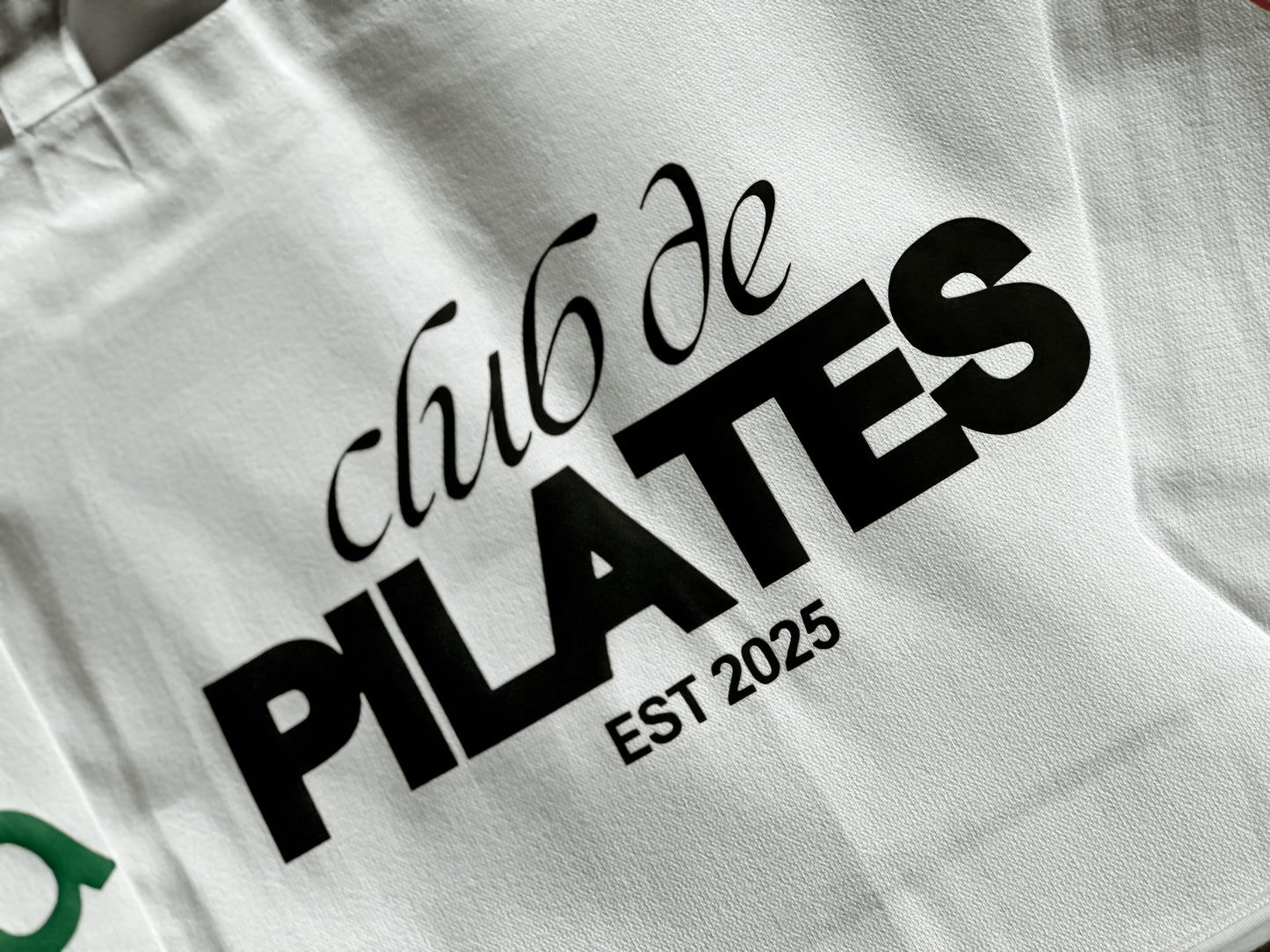 White bag with 'Club de Pilates' text and 'Est. 2025' on a white background