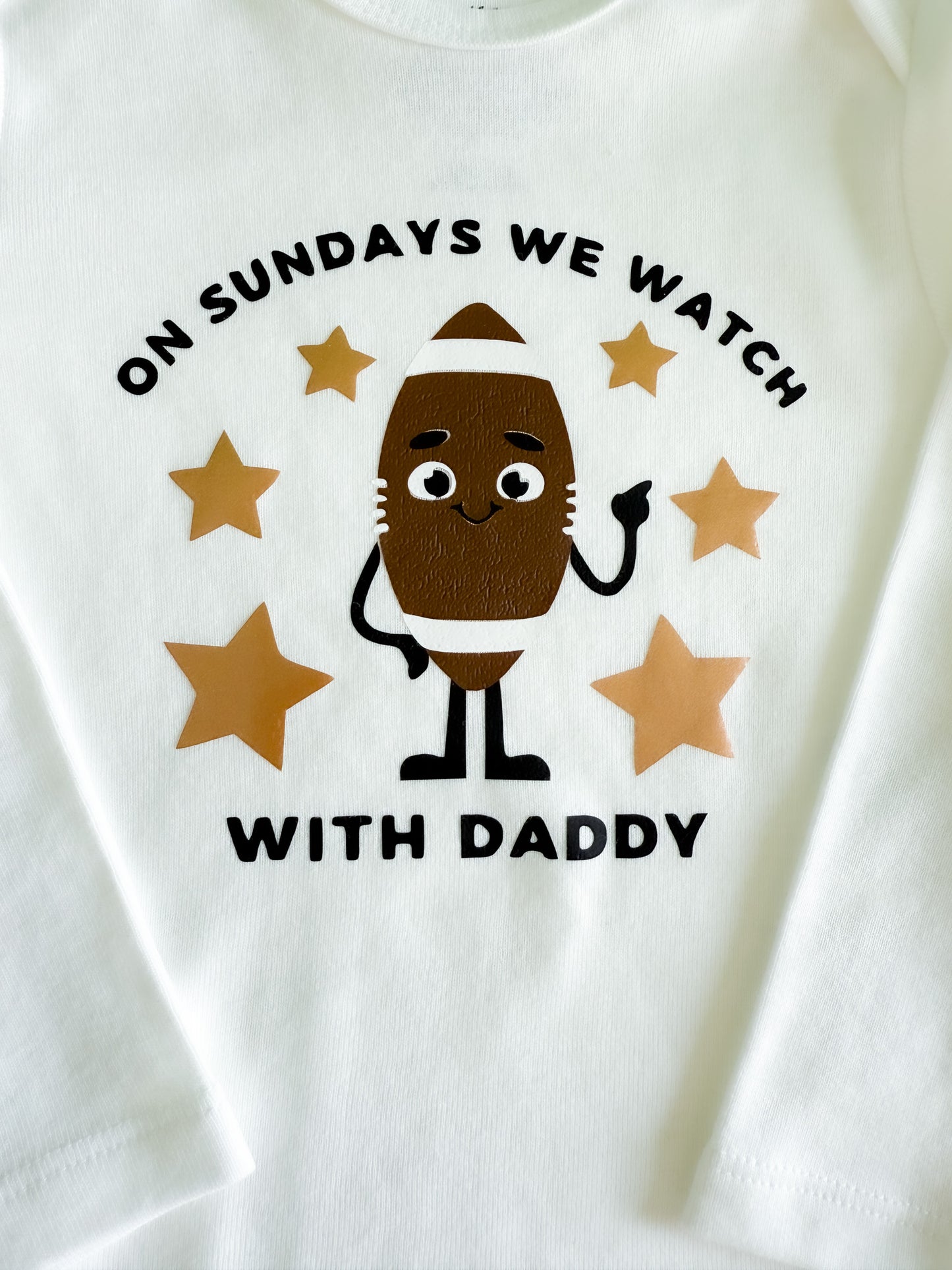 White long sleeve baby onesie with a cartoon character and text on a white background