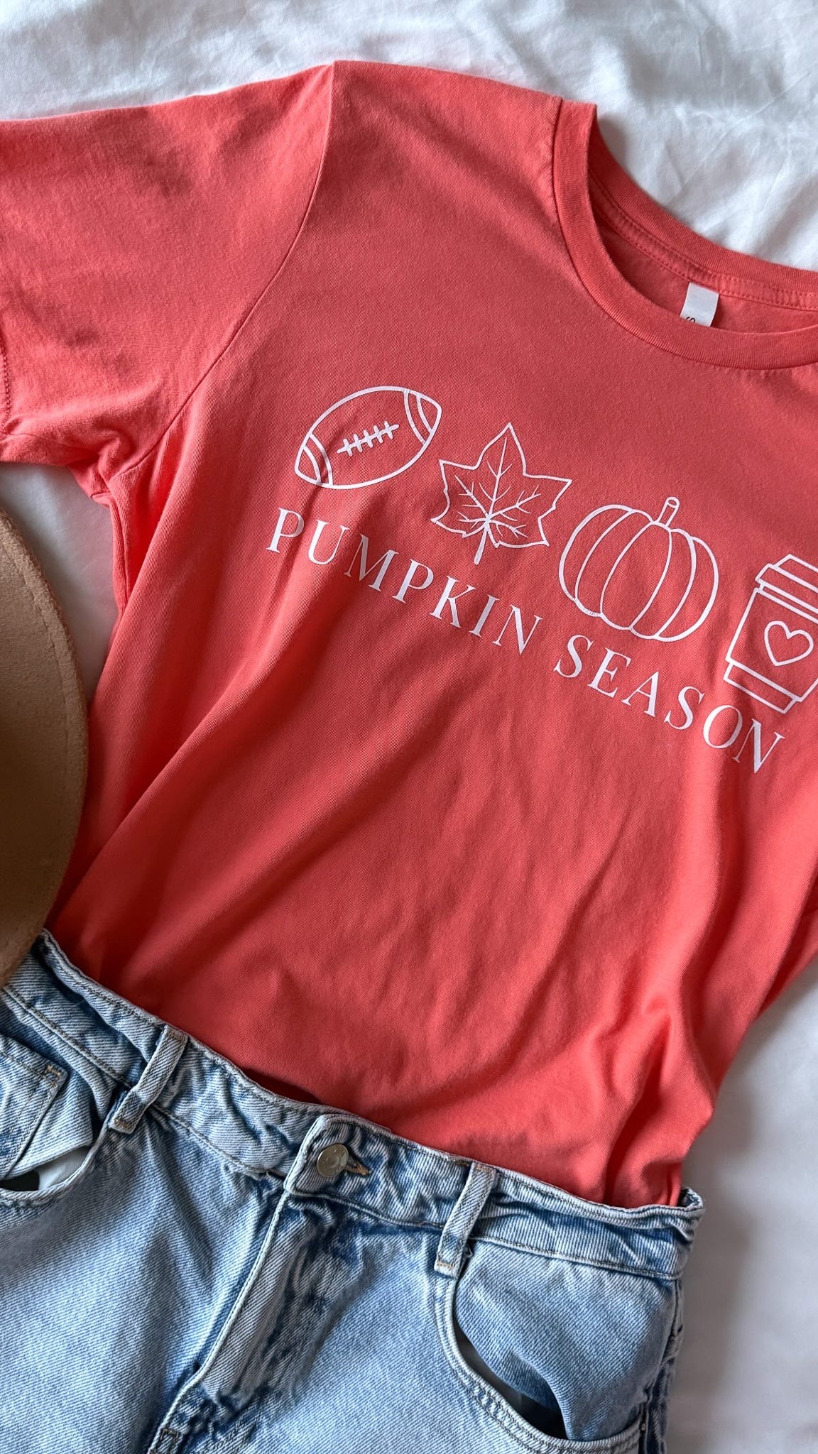 Red t-shirt with 'Pumpkin Season' design on a white surface