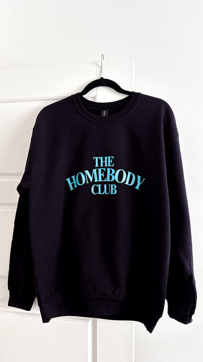 Black sweatshirt with 'The Homebody Club' text on a white background