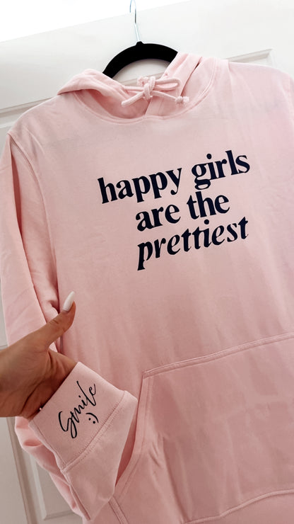 Pink hoodie with 'happy girls are the prettiest' text on a white background