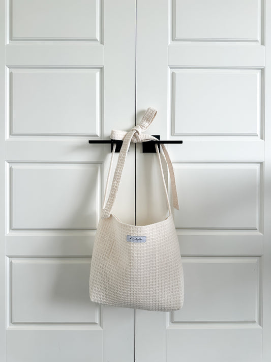 cream tote bag, crafted from premium cotton/jute waffle knit material with elegant bow strap