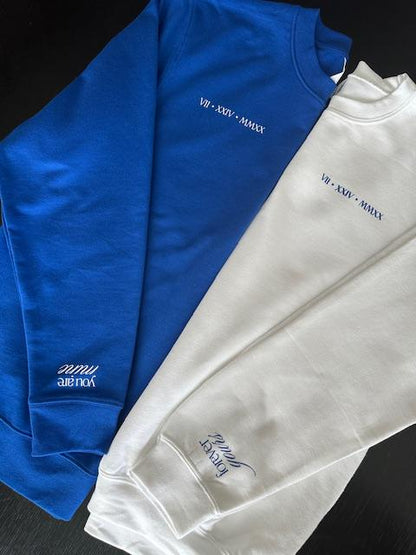 Blue and white sweatshirts with  text on a black background