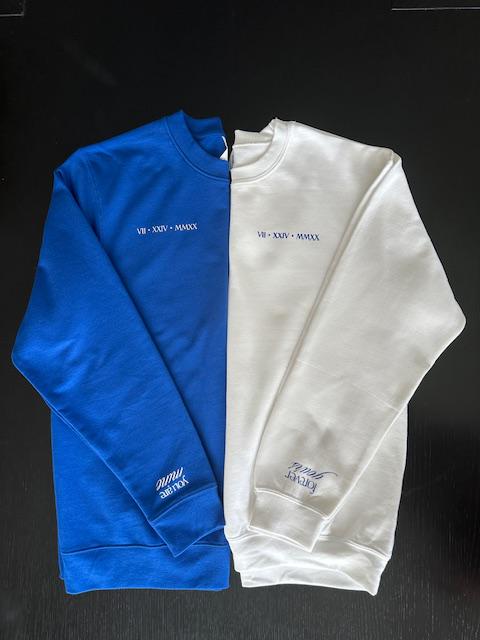 Blue and white sweatshirts with text on a black background