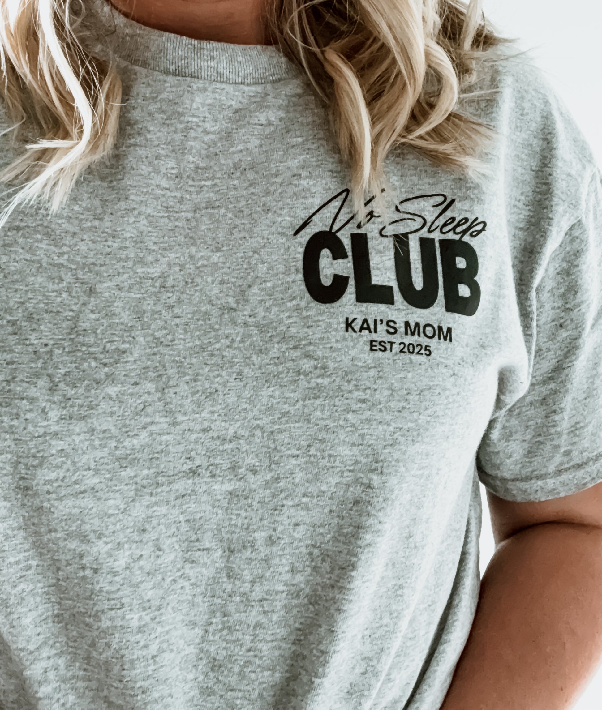Gray t-shirt with 'No Sleep Club' text and personalized details on a person wearing it.