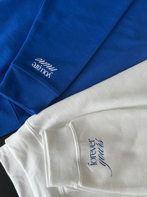 Blue and white clothing with vinyl text on a blue background