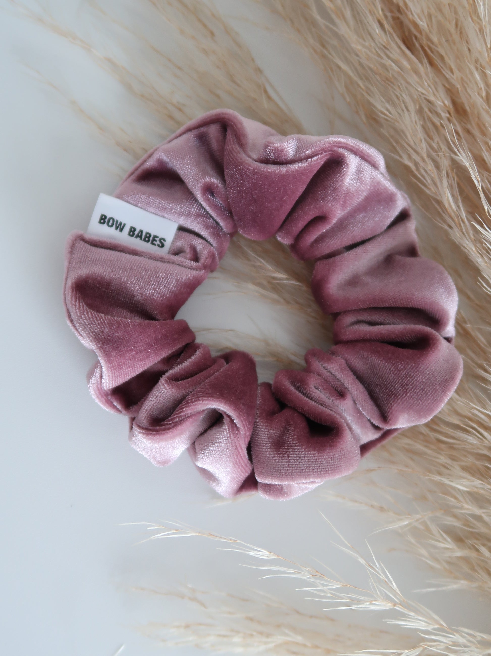Pink scrunchie with a label on a light background