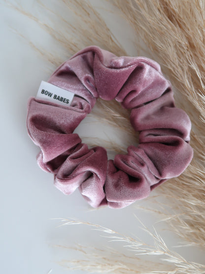 Pink scrunchie with a label on a light background