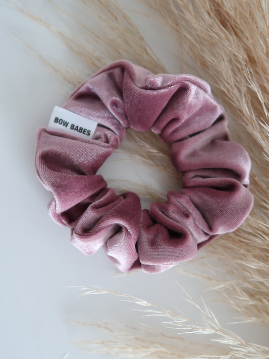 Pink scrunchie with a label on a light background