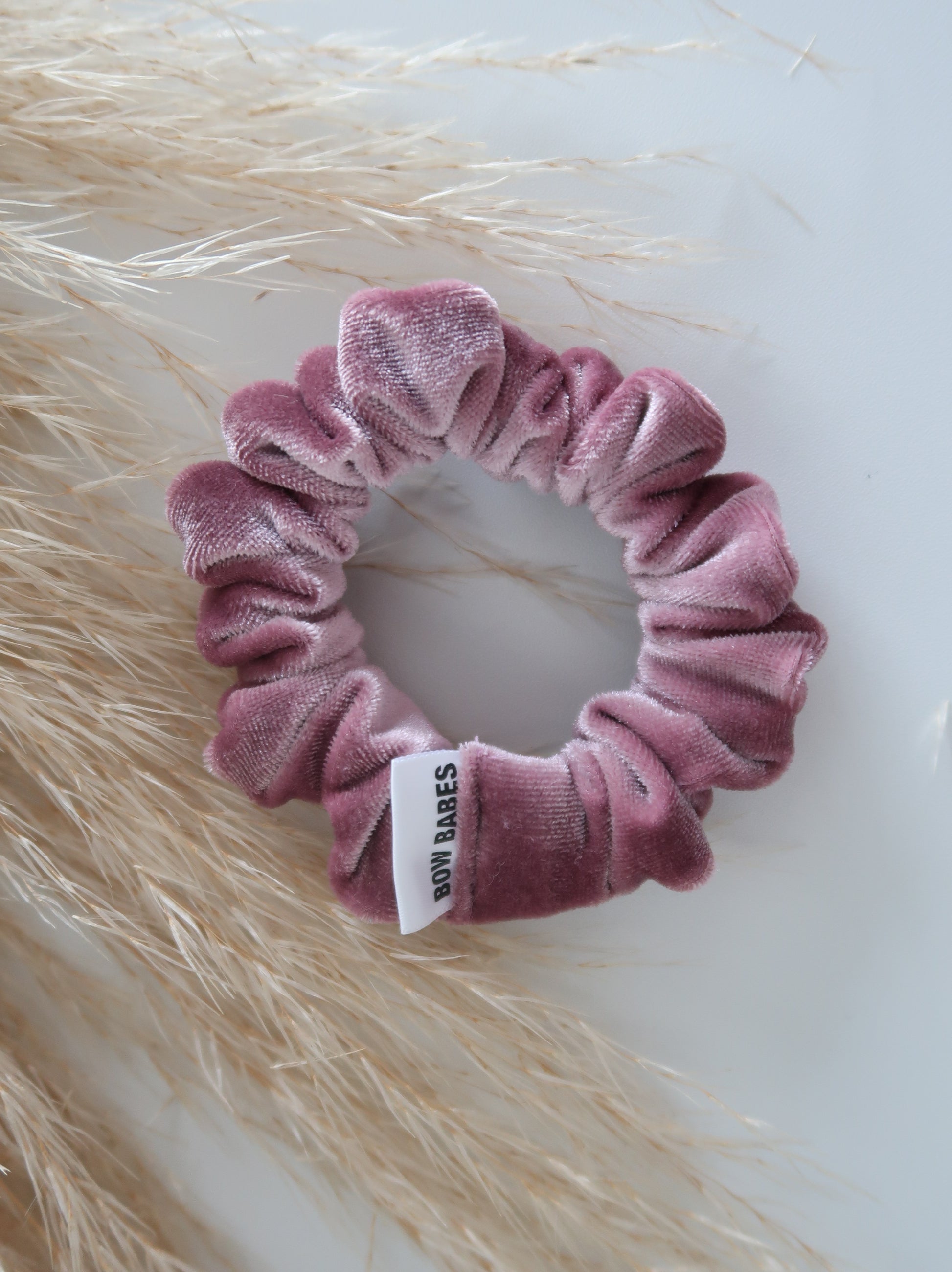 Pink scrunchie with a label on a light background