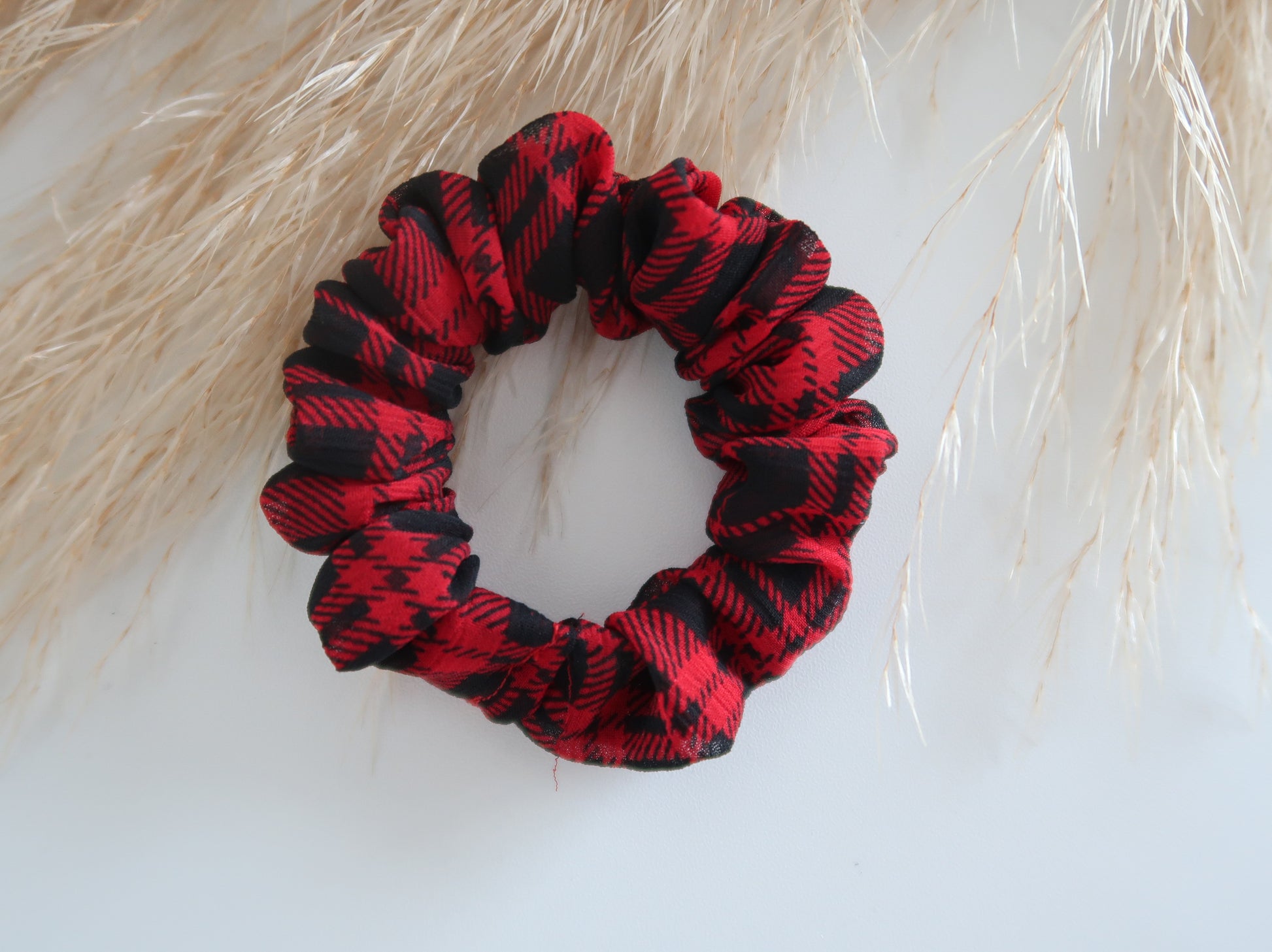 Red and black plaid scrunchie on a light background
