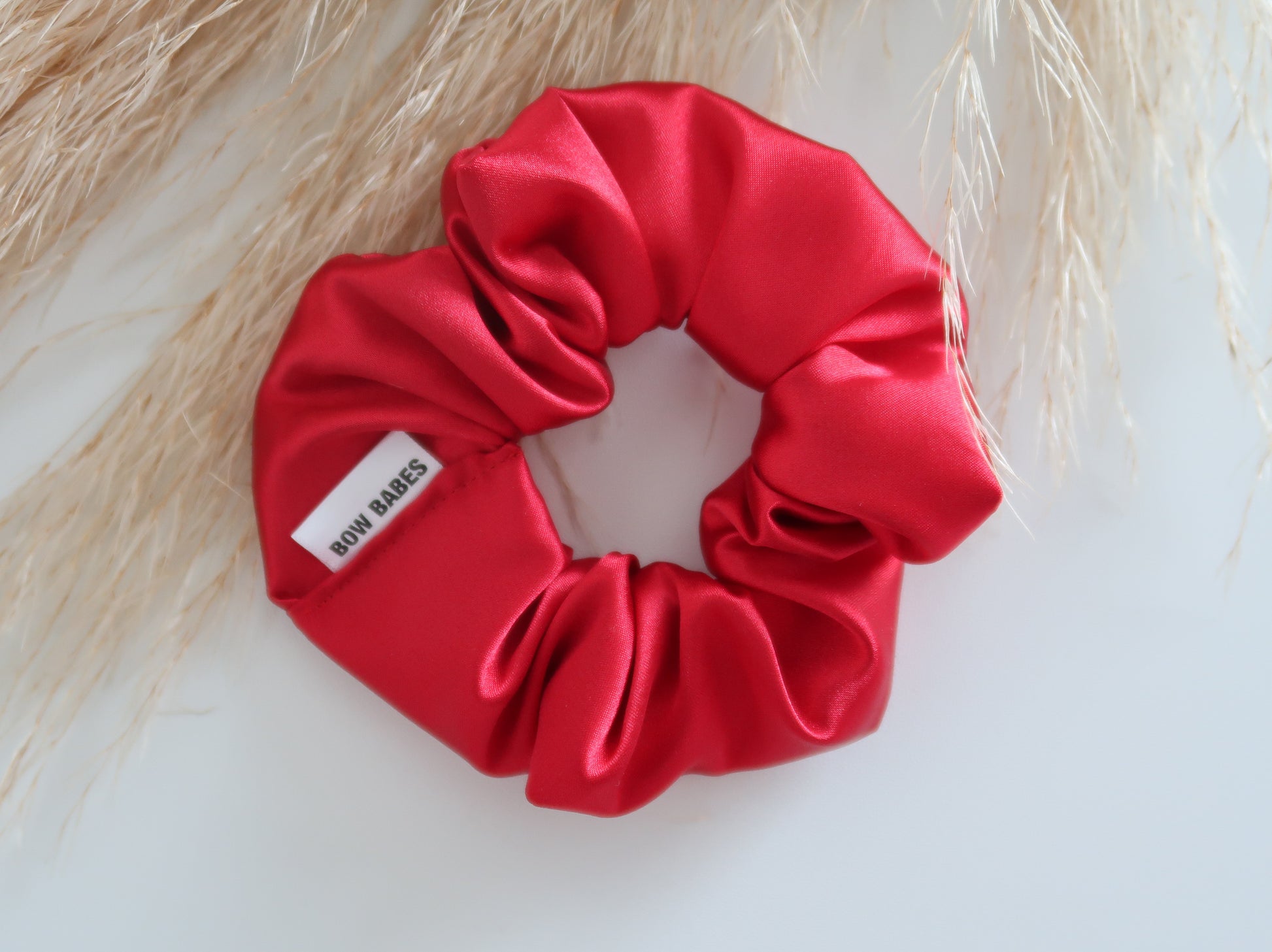 Red scrunchie with a label on a light background