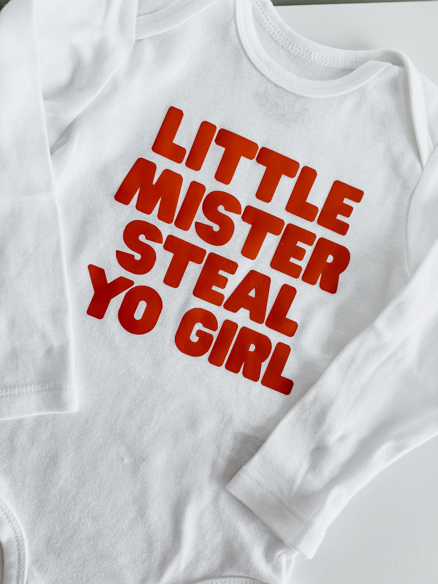 White sweatshirt with red text 'LITTLE MISTER STEAL YO GIRL' on a white background
