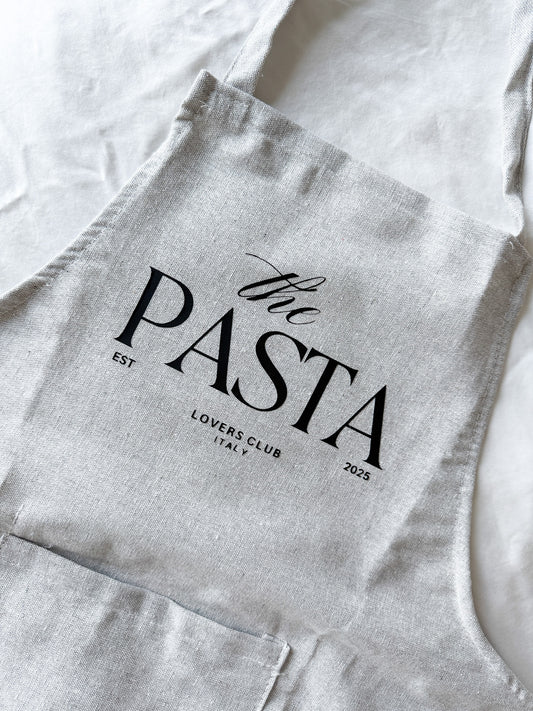 Gray apron with 'the PASTA LOVERS CLUB' text on a white background