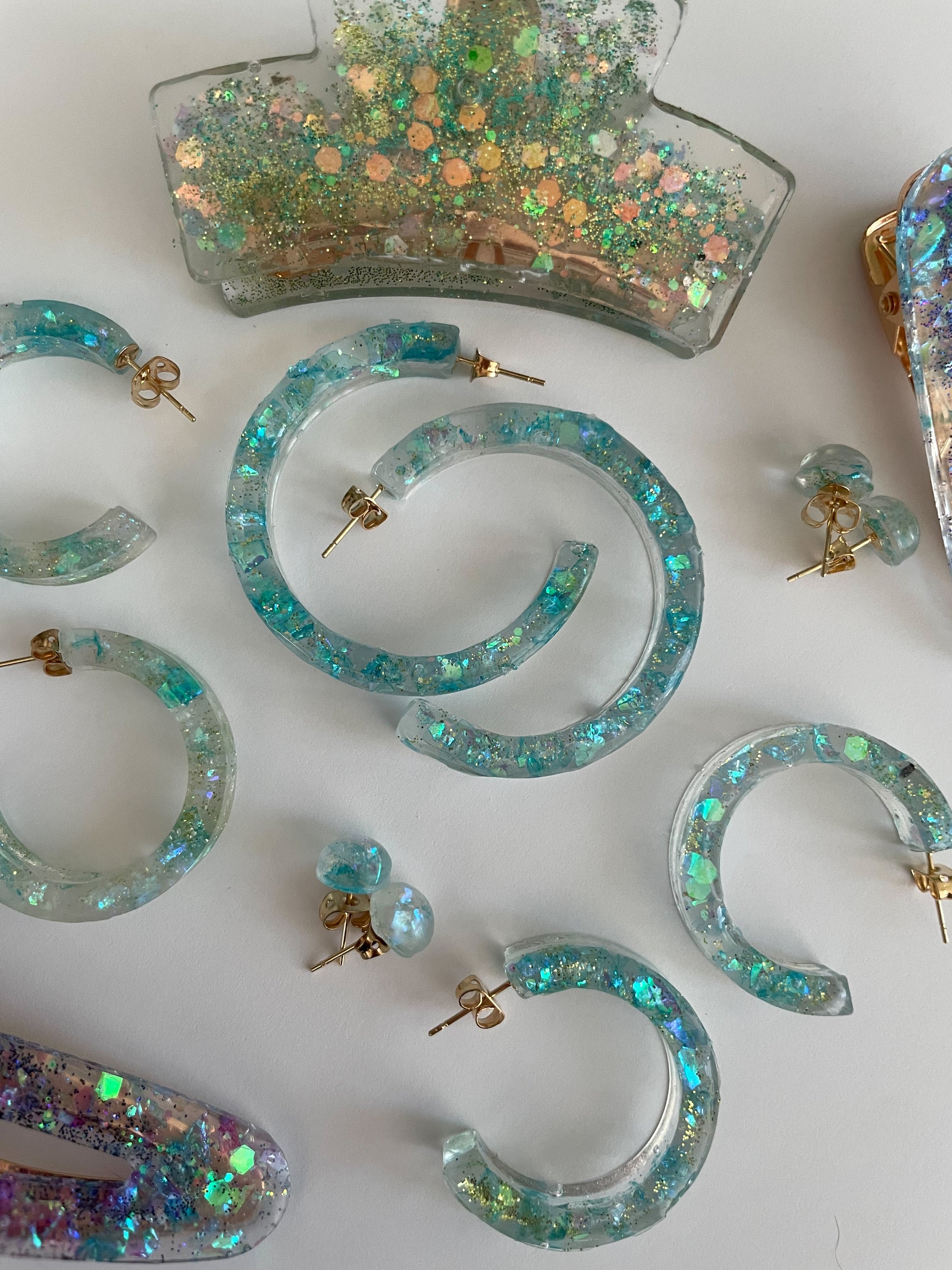 various turquoise sparkly earrings in resin