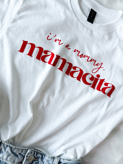 White t-shirt with red text 'i'm a mommy. mamacita' on a white background