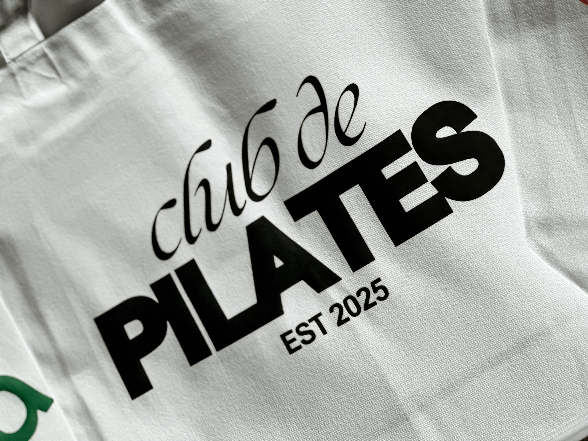 White bag with 'Club de Pilates' text and 'Est. 2025' on a white background