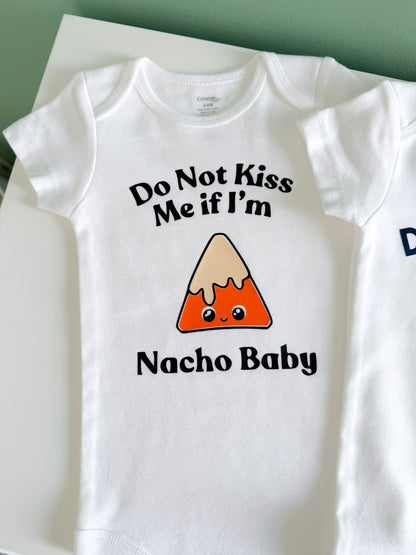 White baby onesie with nacho design and text on a white background