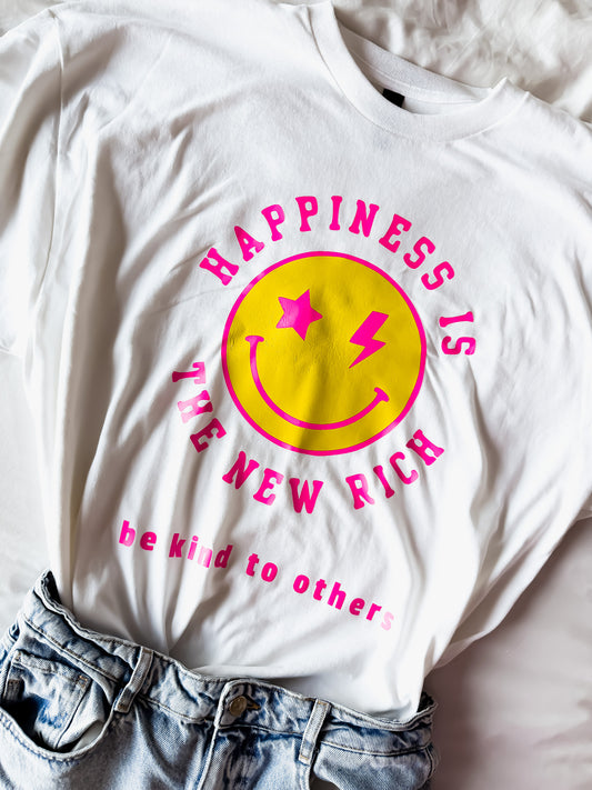 White t-shirt with pink and yellow graphic design on a light background