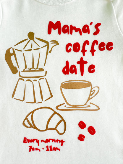 White shirt with coffee-themed design featuring a coffee maker, cup, croissant, and text.