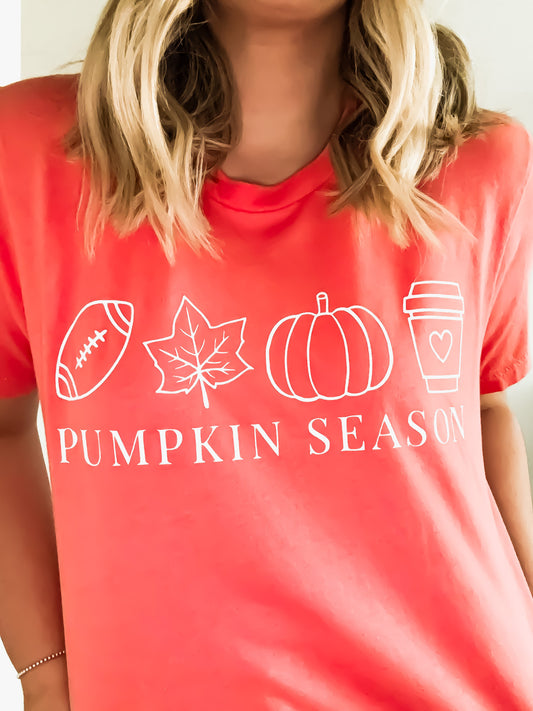Person wearing a red t-shirt with 'Pumpkin Season' graphic design.