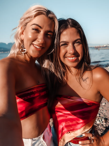 two women wearing silk summer tops on the beach