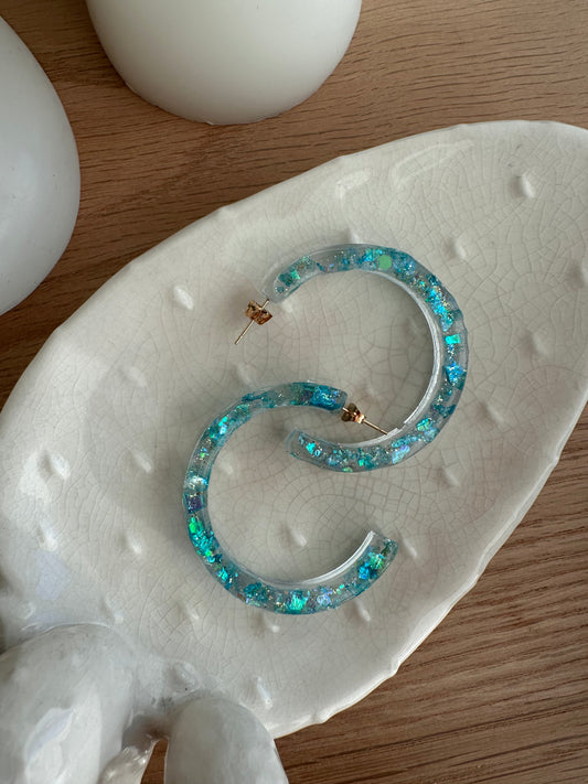large sparkly resin earrings in turquoise color